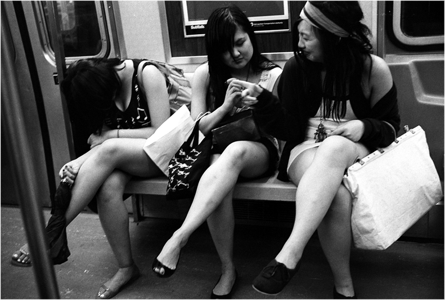 women sitting on subway
