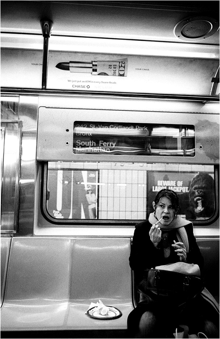 woman applying lipstick with King Kong